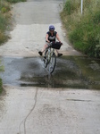 SX27585 Jenni cycling through stream.jpg